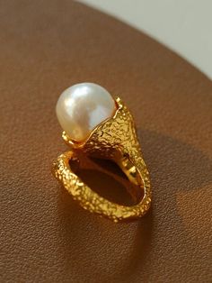 Indulge in timeless elegance with our Vintage Floral Orb Round Baroque Pearl Rings. Featuring a delicate floral design and lustrous baroque pearls, these rings add a touch of vintage charm and sophistication to any outfit. Metal: 18K Recycled Gold Plated On Brass Gemstone:Freshwater Baroque Pearl Ring Dimensions: Height 20mm Fits Ring Sizes: US 6-8 Weight:17g Rings Pearl, Pearl Rings, Edison Pearls, Open Rings, Tiger Eye Stone, Ring Sizes, Recycled Gold, Open Ring, Pearl Size