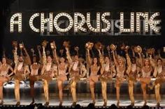 a group of women standing on top of a stage