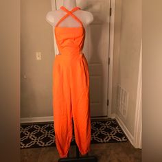 This Vibrant Colored Jumpsuit Is Very Cute, It Has The Criss-Cross Straps And Open Back. Size M 100%Polyester L=40” Waist =14” Nwot Orange Jumpsuits And Rompers For Summer Night Out, Summer Orange Jumpsuits And Rompers For Night Out, Orange Fitted Jumpsuits And Rompers For Spring, Fitted Orange Jumpsuits And Rompers For Spring, Orange Stretch Jumpsuits And Rompers For Spring, Spring Fitted Orange Jumpsuits And Rompers, Spring Orange Fitted Jumpsuits And Rompers, Cotton Jumpsuits And Rompers For Spring Party, Cotton Jumpsuits And Rompers For Night Out In Spring