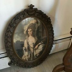 an antique portrait of a woman is on display