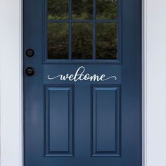 a blue front door with the words welcome written on it in cursive font