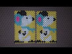 two cats cross stitched together on a piece of knitted material with black and yellow background