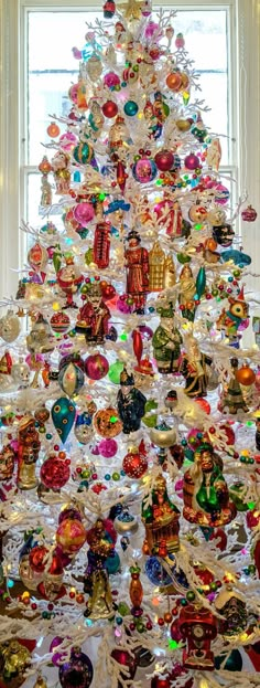 a white christmas tree with many ornaments on it