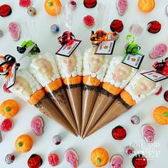 an assortment of candies and candy arranged in the shape of a fan on a white surface