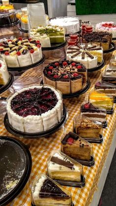 a table topped with lots of cakes and pies on top of plates next to each other