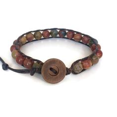 This gemstone bracelet for men is made with 8mm Picasso Jasper Beads individual woven onto natural dark brown leather cord. This men's gemstone bracelet would make a great addition to your wardrobe. The deep colors of greens, browns and burgundy run throughout the beads. Each bracelet is made with top quality leather and gemstone beads. To choose the proper length, simply measure your wrist and add as much length as you want for a comfortable fit. Adjustable Leather Bracelets With Natural Stones, Adjustable Hand Wrapped Leather Bracelet With Round Beads, Adjustable Brown Beaded Bracelet With Gemstone Beads, Adjustable Brown Gemstone Beaded Bracelets, Adjustable Hand-wrapped Beaded Leather Bracelet, Brown Braided Bracelets With 8mm Beads, Adjustable Leather Beaded Bracelets With Round Beads, Brown Braided Bracelets With Hand-strung Round Beads, Adjustable Brown Round Bracelets