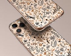 two iphones with floral designs on them, one in gold and the other in white