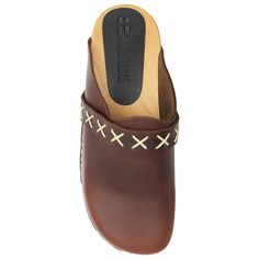 "The Pixie Wooden Clog sticks to its roots by encompassing the classic Swedish clog that we know today. Luxurious full grain leather upper with decorative stitching on the matching strap. o Hand-Made in Europe o Full grain Leather o Decorative stitching o Genuine Wood Outsole with PU tread o FussForm* shaped outsole that follows the natural contours of your toes. More room to wiggle your toes! o Heel measures approximately 2\" o Platform measures approximately 0.75\" *FussForm outsole provides a Leather Clogs With Stitched Sole And Closed Toe, Brown Leather Clogs With Stitched Sole, Bastad Clogs, Swedish Clogs, Wooden Clogs, Natural Contour, Decorative Stitching, Leather Clogs, Full Grain Leather