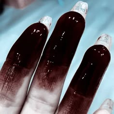 a woman's hand with some shiny nails on it