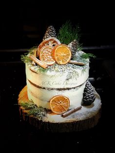 a cake decorated with orange slices and pine cones