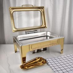 a gold and silver mirror sitting on top of a table next to a pair of scissors