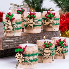 six decorated candles sitting on top of a table