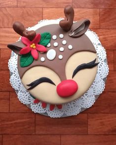 there is a cake that looks like a reindeer's face on top of a doily