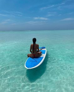 a person sitting on a surfboard in the ocean