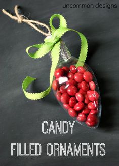 a candy filled ornament hanging from a string on a black background with the words candy filled ornaments