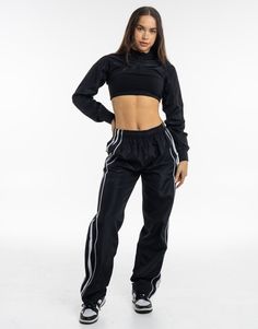 Meet the High Cut Hoodie, the perfect layering piece that deserves to be a part of the all-year rotation. The ultra cropped length is the High Cut Hoodie's best attribute, great for showing off your sportsbra and/or bikini. Add in a hoodie and you've got a top that can provide style and warmth - Super soft cotton/polyester blend - In-trend ultra cropped silhouette - Large hood - Designed to flatter every size - Worn by our inhouse team for the perfect fit 62% Cotton, 38% Polyester Bella is weari Sporty Activewear For Fall Streetwear, Black Nylon Track Jacket For Training, Black Fitted Windbreaker For Sports, Fitted Black Windbreaker For Sports, Urban Activewear For Sports Season And Streetwear, Black Fitted Nylon Track Jacket, Urban Activewear For Streetwear And Sports Season, Urban Activewear For Sports Season, Sporty Moisture-wicking Track Jacket