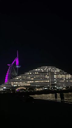 the building is lit up with purple lights