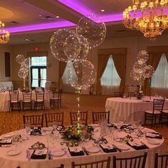 a banquet room set up with balloons and tables