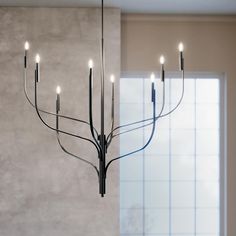 a chandelier with six lights hanging from it's sides in a room