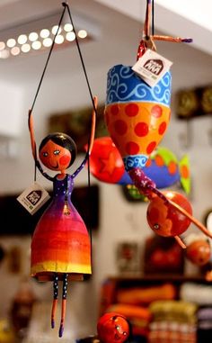 a colorful doll hanging from a string in a store