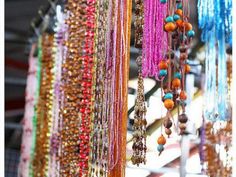 colorful beads hanging from the ceiling in a store