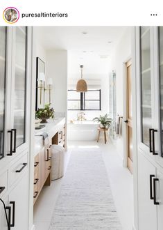 an open door leading to a white bathroom