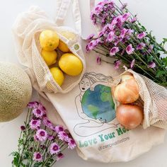 various fruits and vegetables are in bags on the table next to each other, including lemons