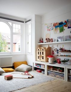 a child's room with toys and bookshelves