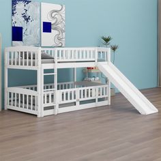 a white bunk bed with a slide next to it