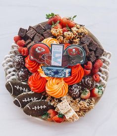 a football themed platter with cookies, candy and candies