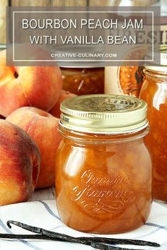 jars filled with peach jam sitting on top of a table next to apples and other fruit