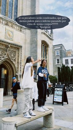 two people standing on a bench in front of a building with a speech bubble above them