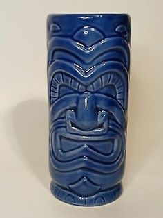 a blue vase with a face on it