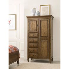 a tall wooden cabinet with drawers in a room