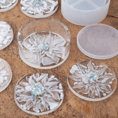 several clear glass plates with flowers on them