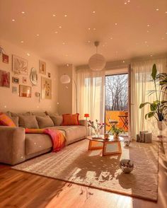 a living room filled with lots of furniture and decor on top of a hard wood floor