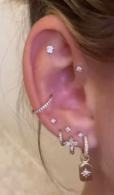 a close up of a person wearing ear piercings