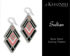 a pair of earrings with pink, black and white designs on it's sides