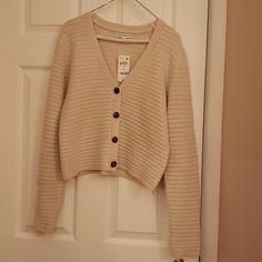 Woman's Long Sleeve 4 Button Front Cardigan. Never Worn. Still Has Tag. 92% Acrylic/ 8% Polyester V-neck Sweater With Button Closure For Day Out, Spring Cream Sweater With Button Closure, Cream Cardigan With Buttons For Spring, Cream Button Closure Sweater For Spring, V-neck Button Cardigan For Day Out, V-neck Outerwear With Buttons For Day Out, Beige Button-up Cardigan, Beige Buttoned Cardigan For Day Out, Everyday Button-up Sweater With Button Closure