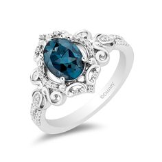 a ring with a blue stone surrounded by white diamonds on the sides and an intricate design around it