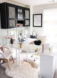 a white desk topped with a computer next to a window