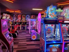 several arcade machines lined up in a room