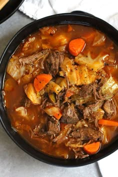 a bowl of beef stew with carrots and potatoes