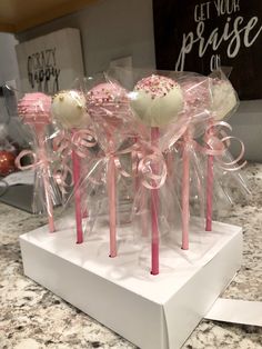 some lollipops are wrapped in cellophane and tied with pink ribbon