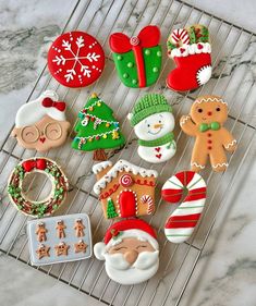 decorated cookies are sitting on a cooling rack