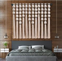 a bedroom with a large bed and wooden wall hangings above the headboard in front of it