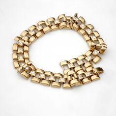 Wonderful and wide, this gold toned choker is 15.5 inches long and 3/4 of an inch wide. It closes securely with a fold over clasp. The style is kind of hybrid, maybe Egyptian revival meets Victorian. The central links are set with cut-glass stones that have little star burst pattern around them in the metal. The links are hollow formed so this piece is not too heavy to wear comfortably, weight is just about 2 ounces. Looks great layered with longer necklaces. Fine vintage condition with minor su Metal Chain Link Jewelry With Gold Clasp, Gold Clasp Chain Link Jewelry, Metal Link Chain Bracelet With Gold Clasp, Gold Chain Bracelet With Rectangular Links For Parties, Gold-tone Chain Metal Bracelet, Gold Metal Chain Link Choker, Gold Chain Link Metal Choker, Retro Gold Chain Jewelry, Gold Link Metal Choker