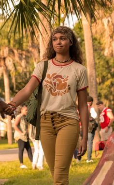 a woman walking down the street holding hands