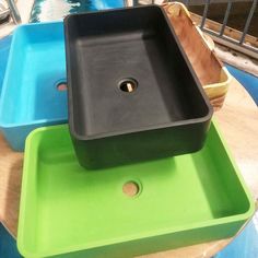 three different colored trays sitting on top of each other