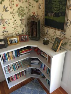 a corner book shelf with many books on it